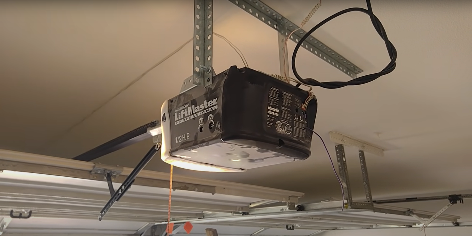 Technician performing garage door opener repair services at Bee Ridge Garage Door Repair, showcasing professional tools and expertise.