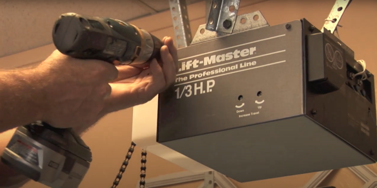 Technician performing garage door opener repair at Bee Ridge Garage Door Repair LLC workshop.
