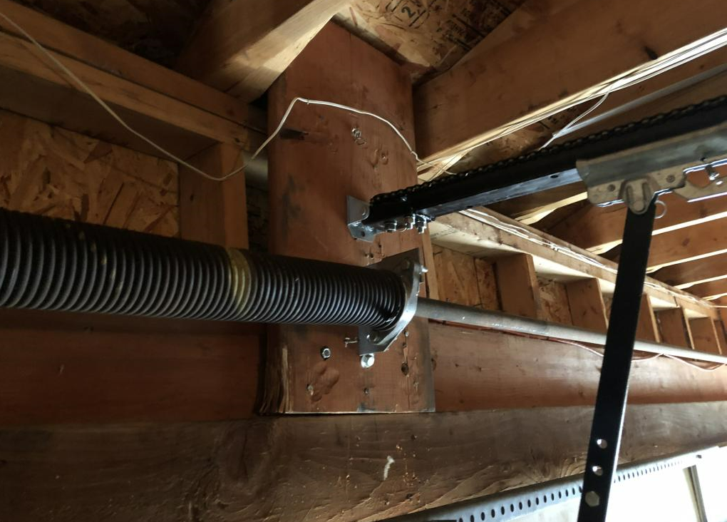 Technician performing garage door spring repair for a residential garage in Bee Ridge, ensuring smooth and safe door operation.