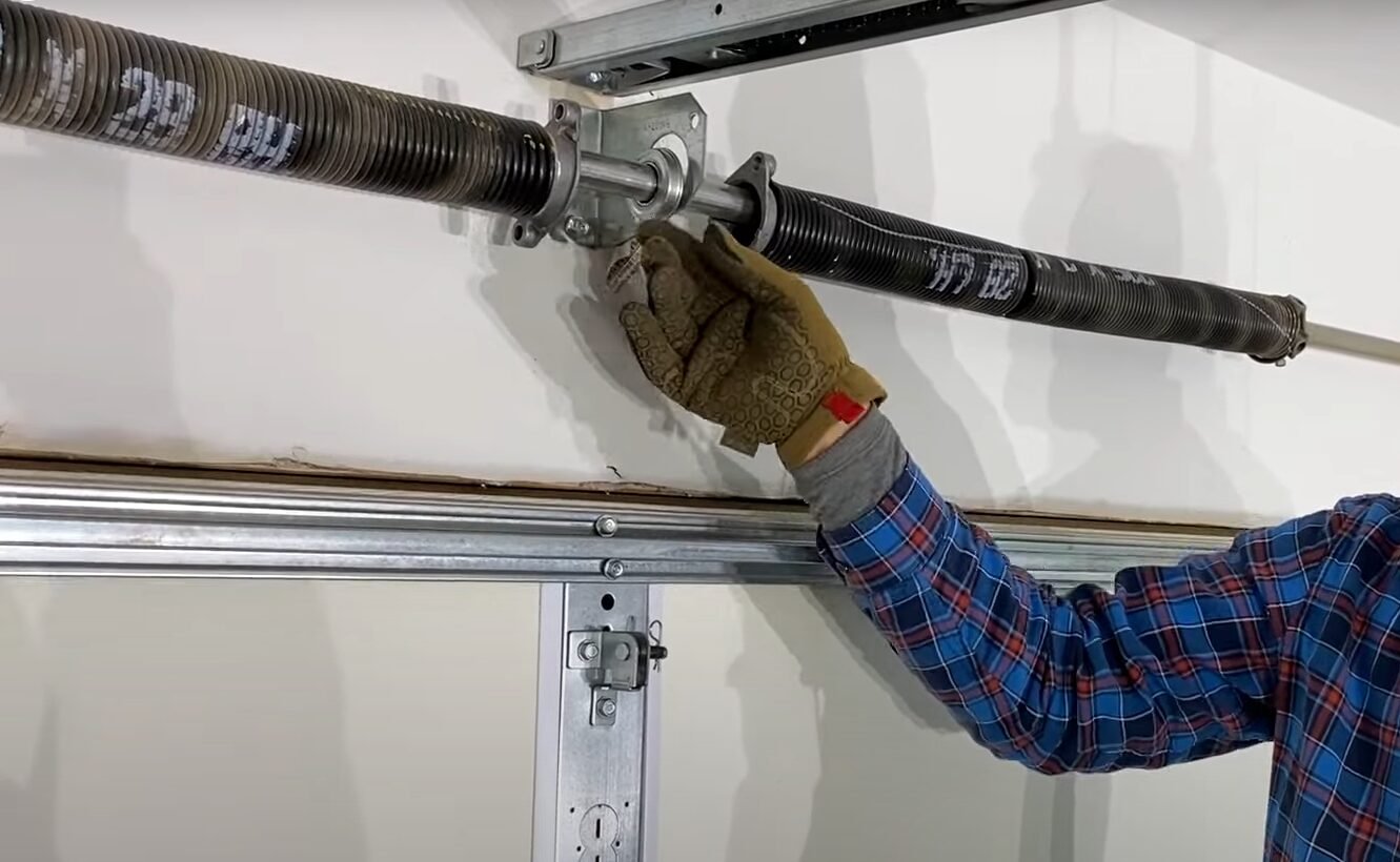 a professional technician performing garage door spring repair at Bee Ridge Garage Door Repair, ensuring safe and efficient operation of residential garage doors.